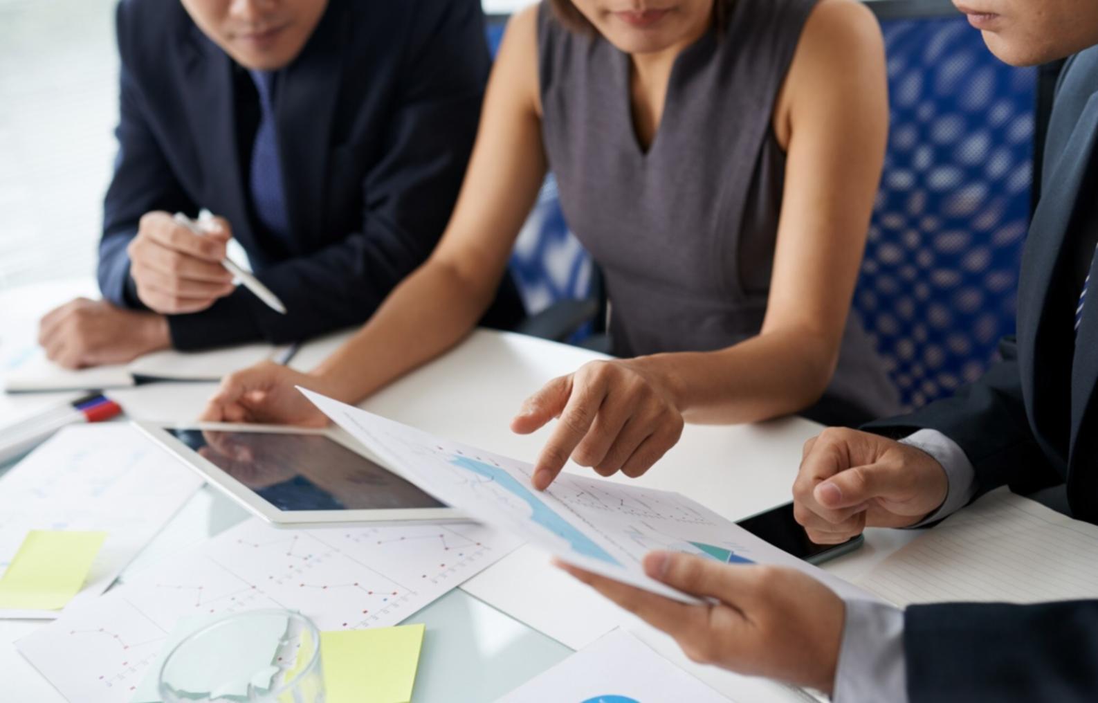 Students reviewing financial documents and investment strategies